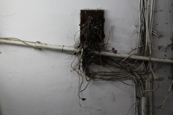 Exposed wiring and neglected piping is common in old buildings in the neighborhood. | Tanya McGovern